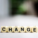 Close-up of letter blocks spelling 'CHANGE', symbolizing transformation and growth.